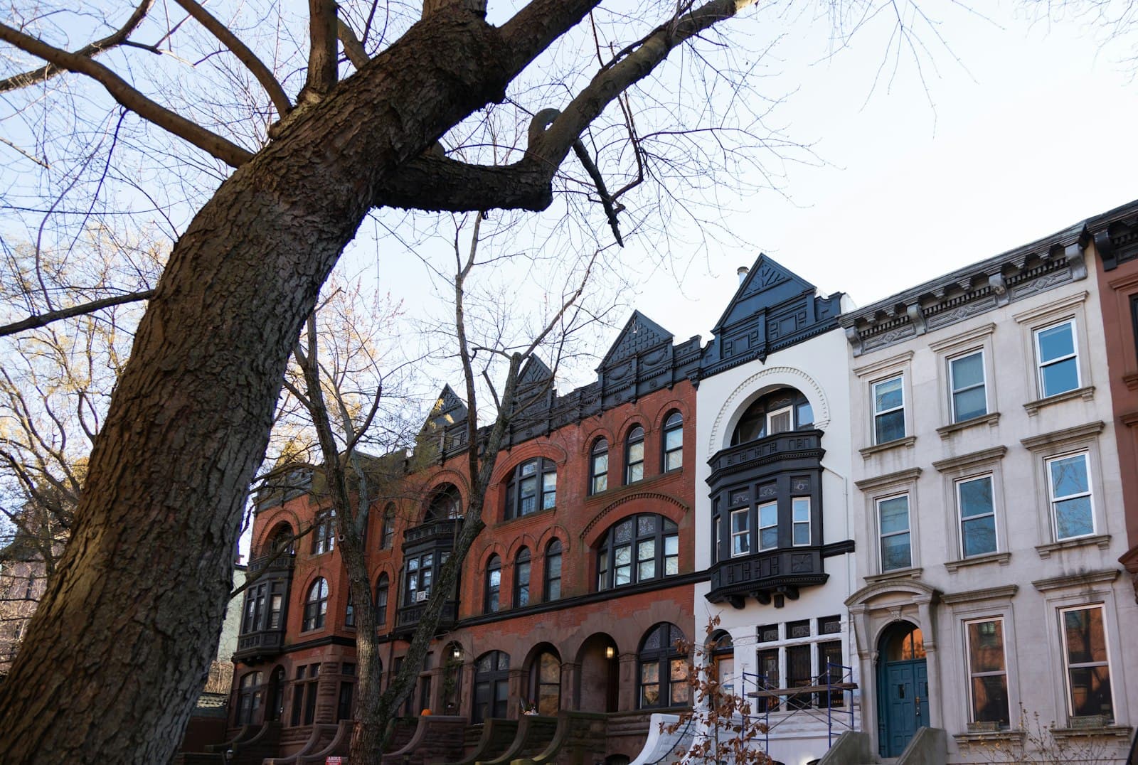 A row of prewar multifamily buildings in New York City
